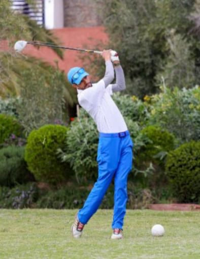 Golfer demonstrating a swing on the course